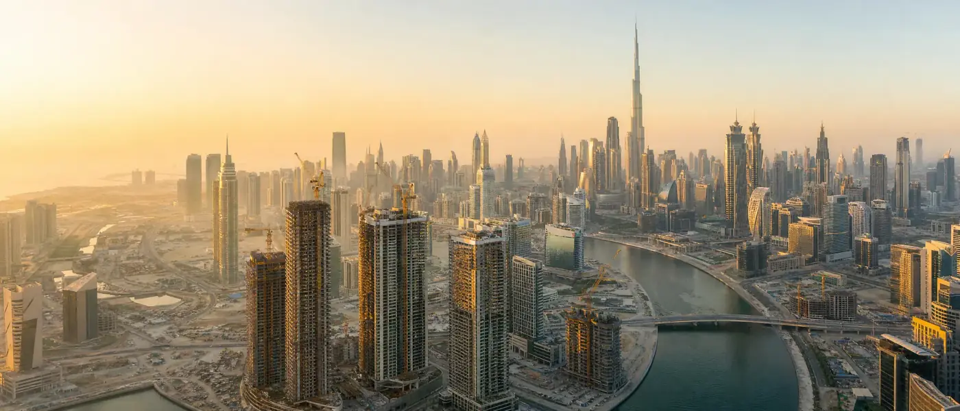 Aerial view of Downtown Dubai and Business Bay at sunrise with new towers under construction